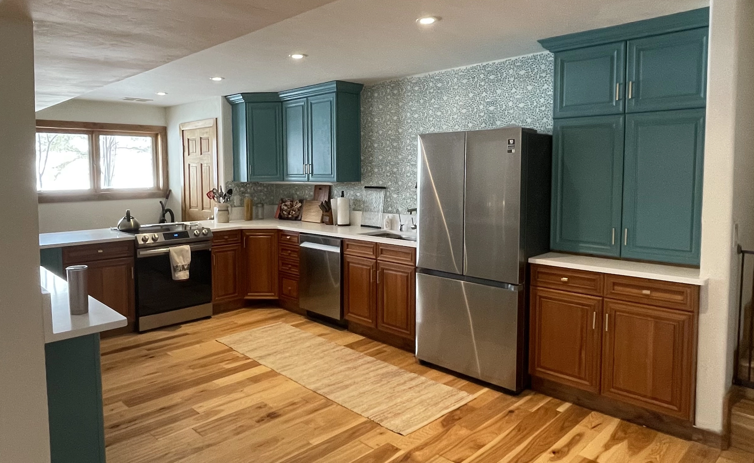 Aqua kitchen showing beautiful wood flooring